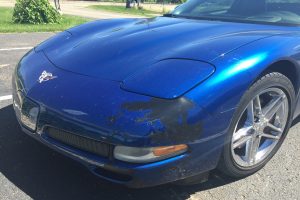 blue Chevy corvette large bumper paint damage
